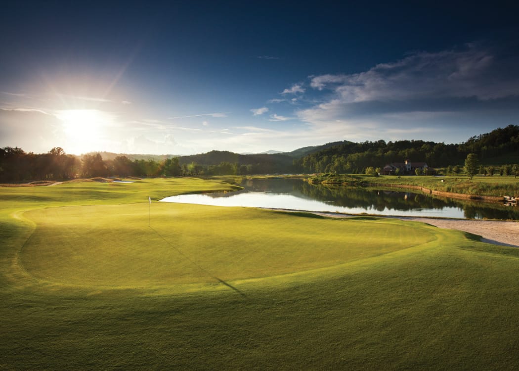 Sunrise over golf green and mountain