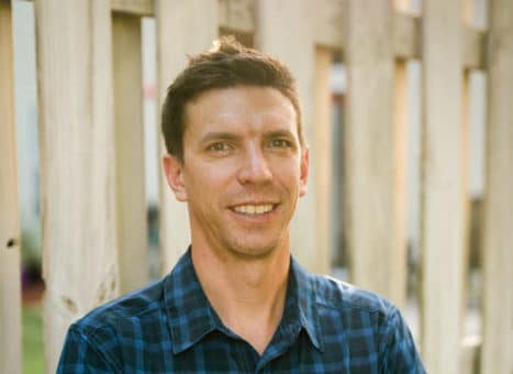 professional headshot of man in plaid shirt