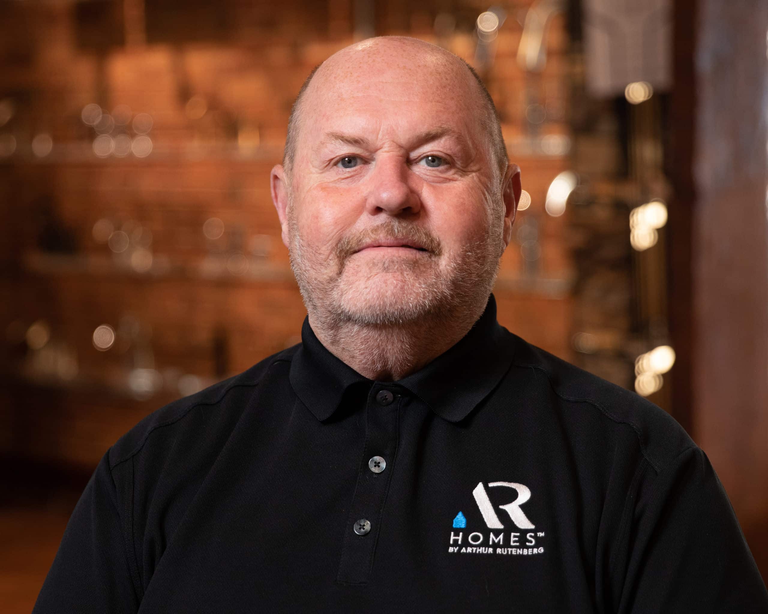 headshot of man in polo
