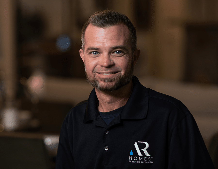Headshot of man in AR Homes polo