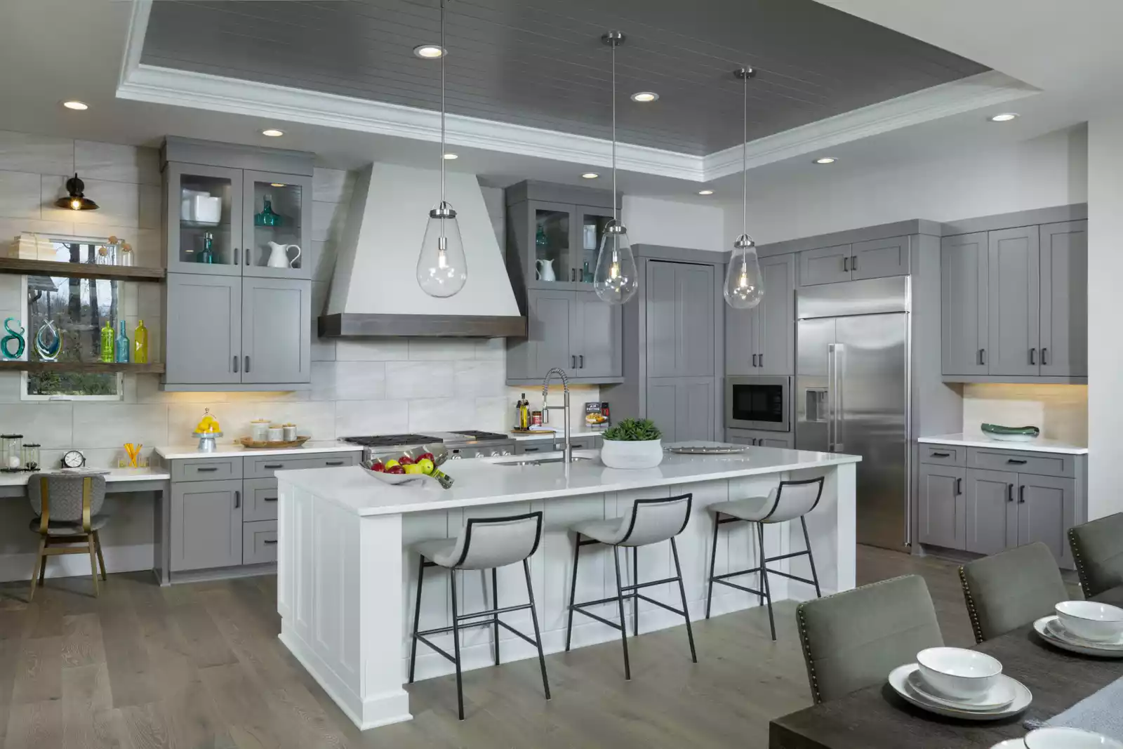 Custom kitchen from Kennedy floor plan model featuring white interior and island