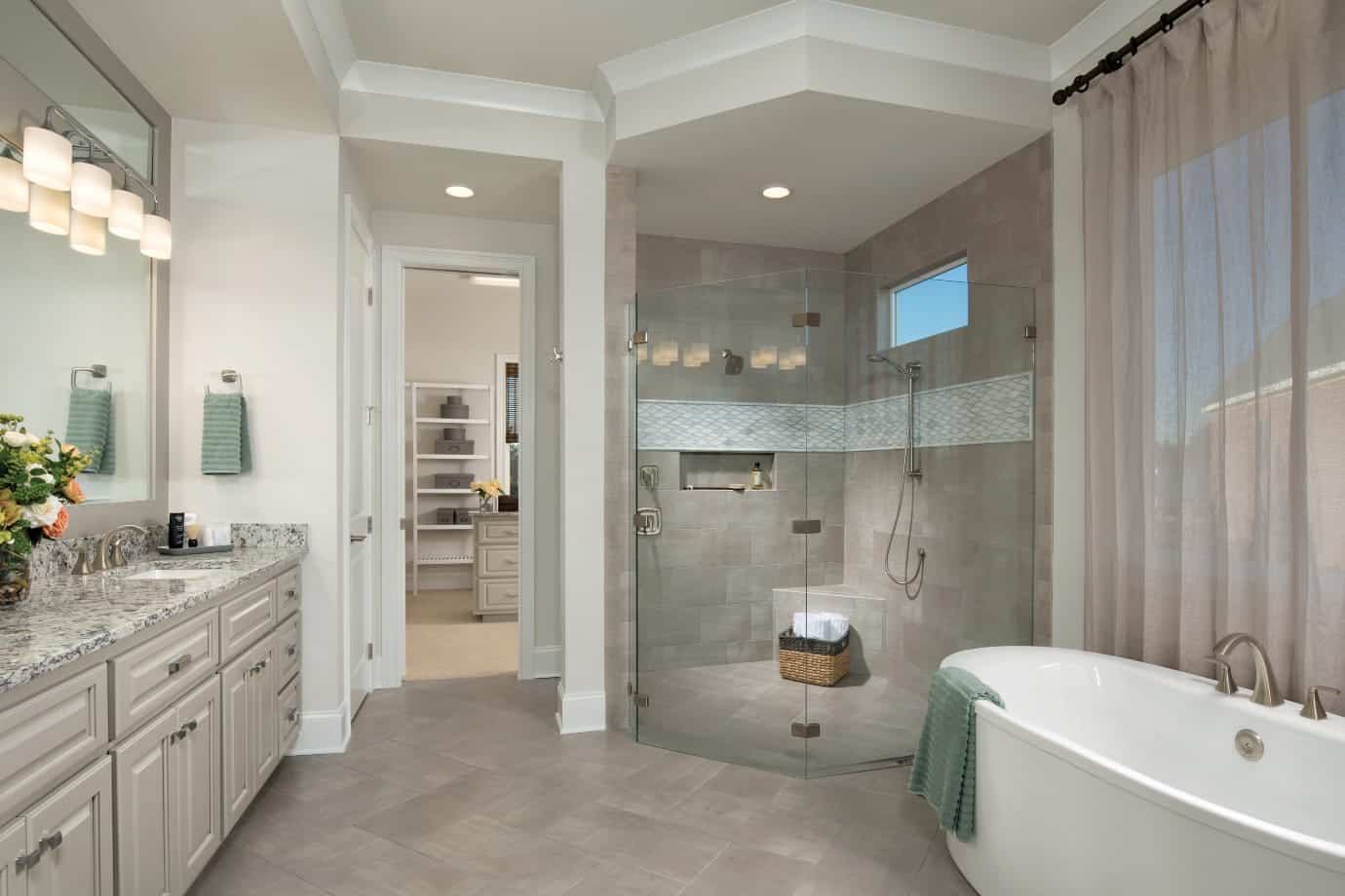 owners suite bathroom with walk shower and tub