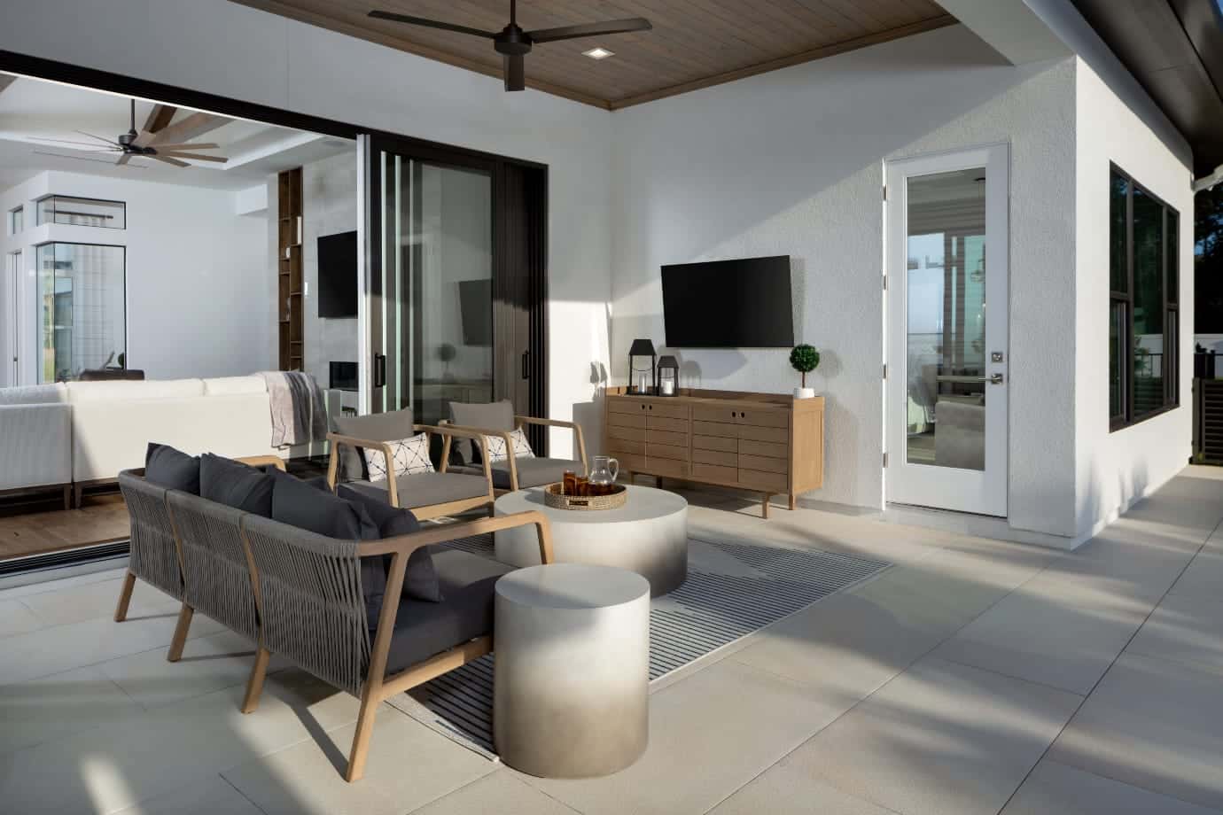 outdoor kitchen with seating looking into hosue