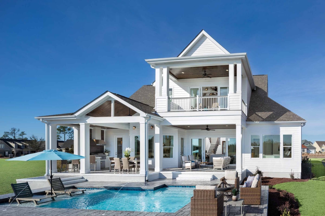exterior model home with pool and two stories