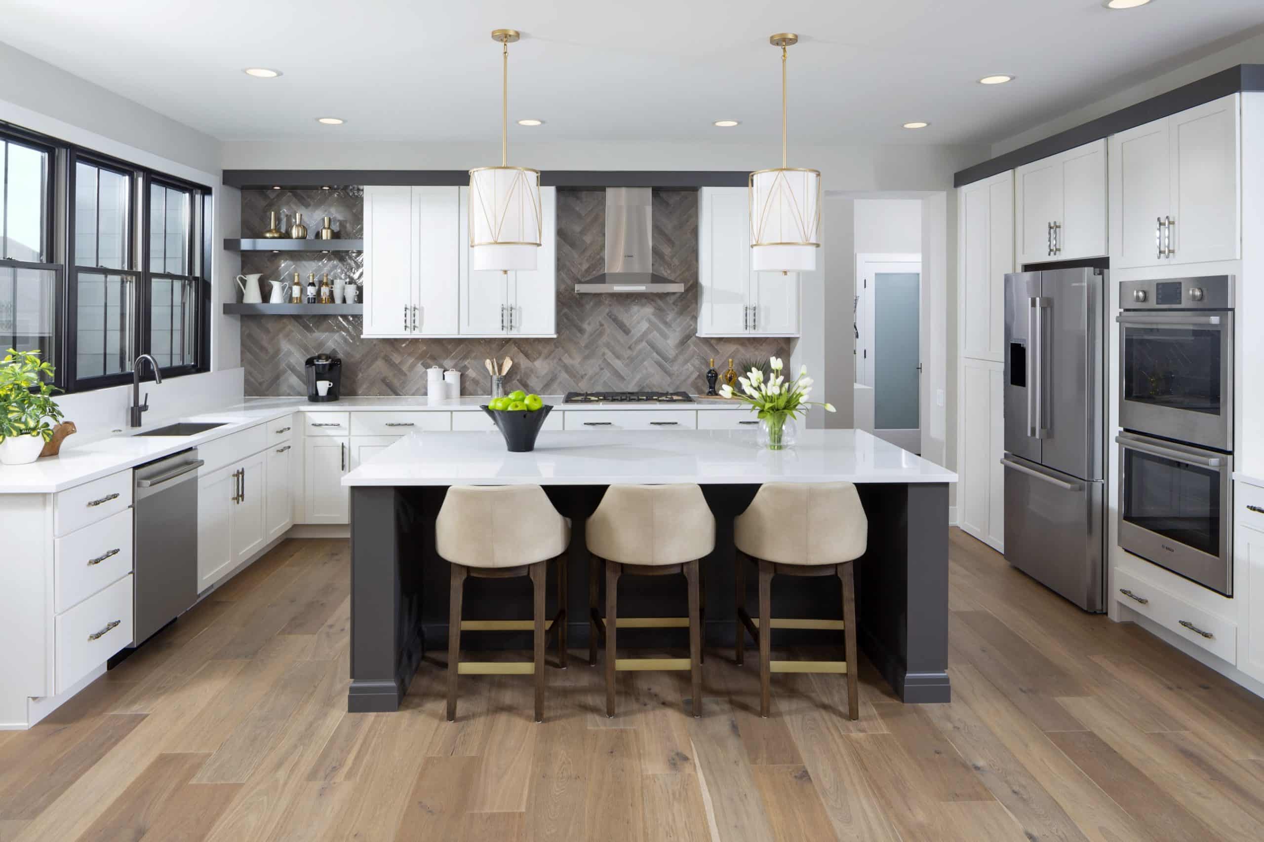 Front view of kitchen island with three chairs overlooking kitchen