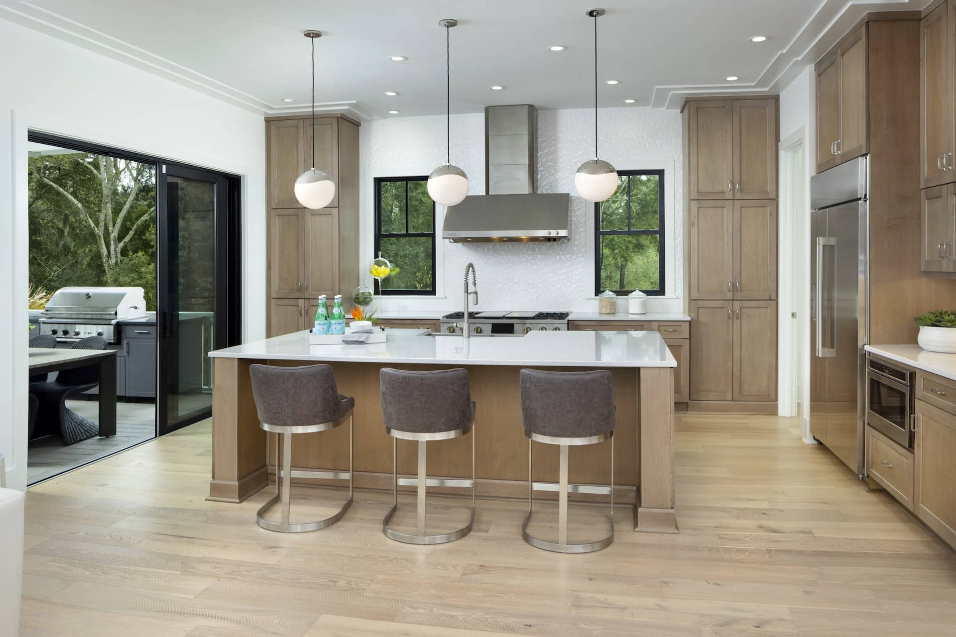 modern kitchen island with chairs and light fixtures