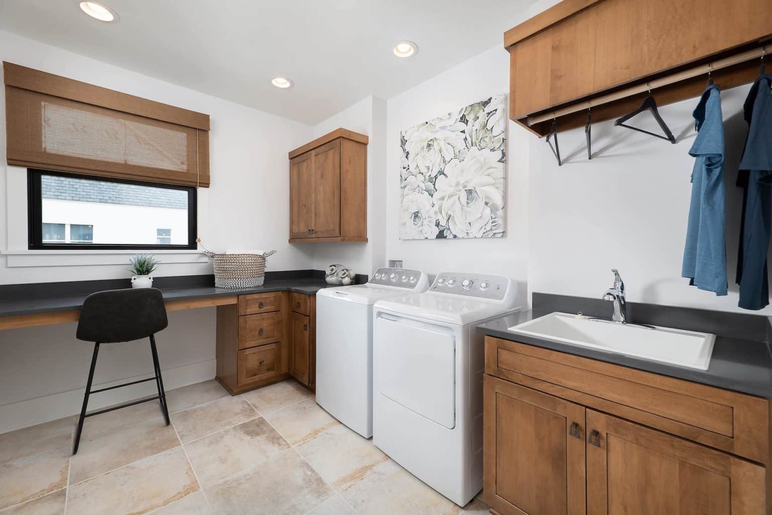 laundry room with window and wooden cabinets