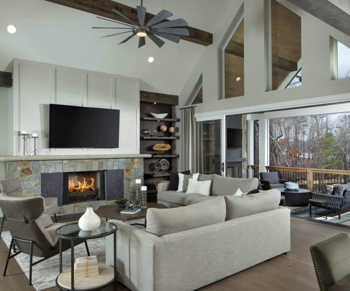 Custom Kennedy home great room with white couch and chairs faced towards fireplace and tv