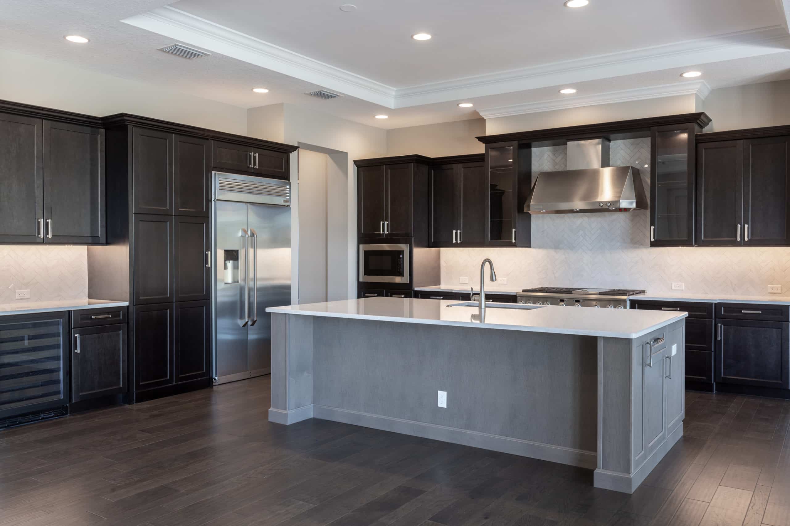 kitchen island with cabinets and steel appliances