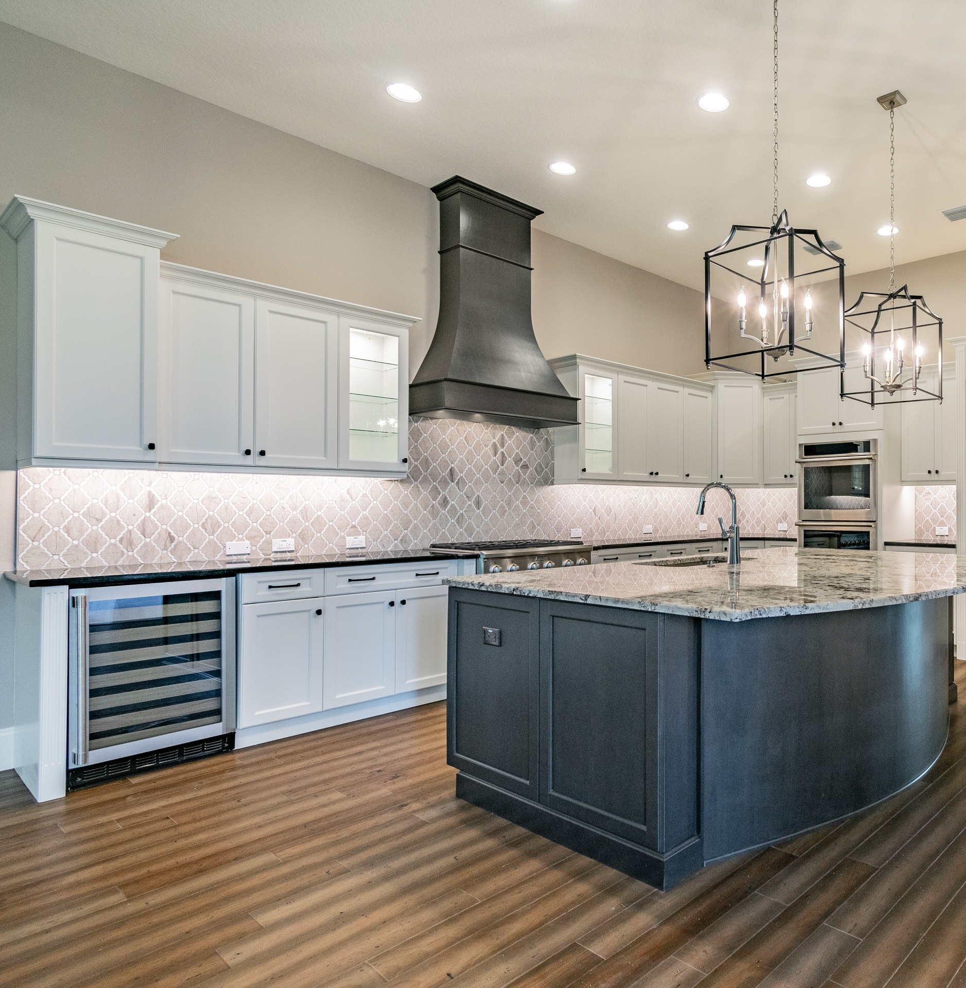 custom kitchen with island and wine fridge in counter