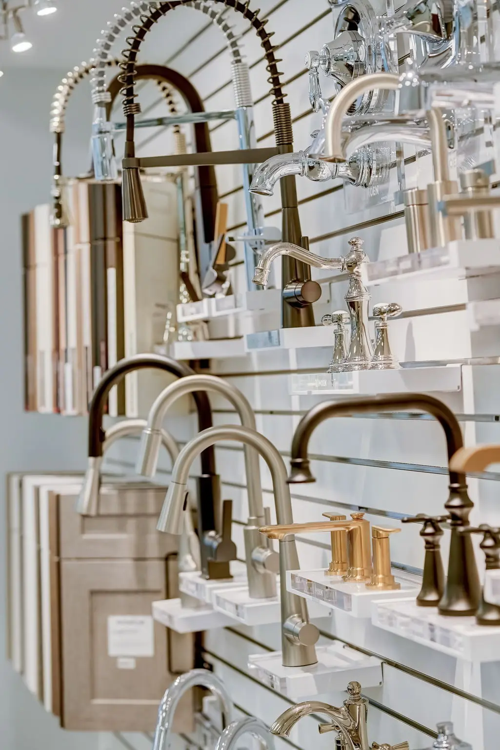 Display wall of sink faucets and cabinet finishes